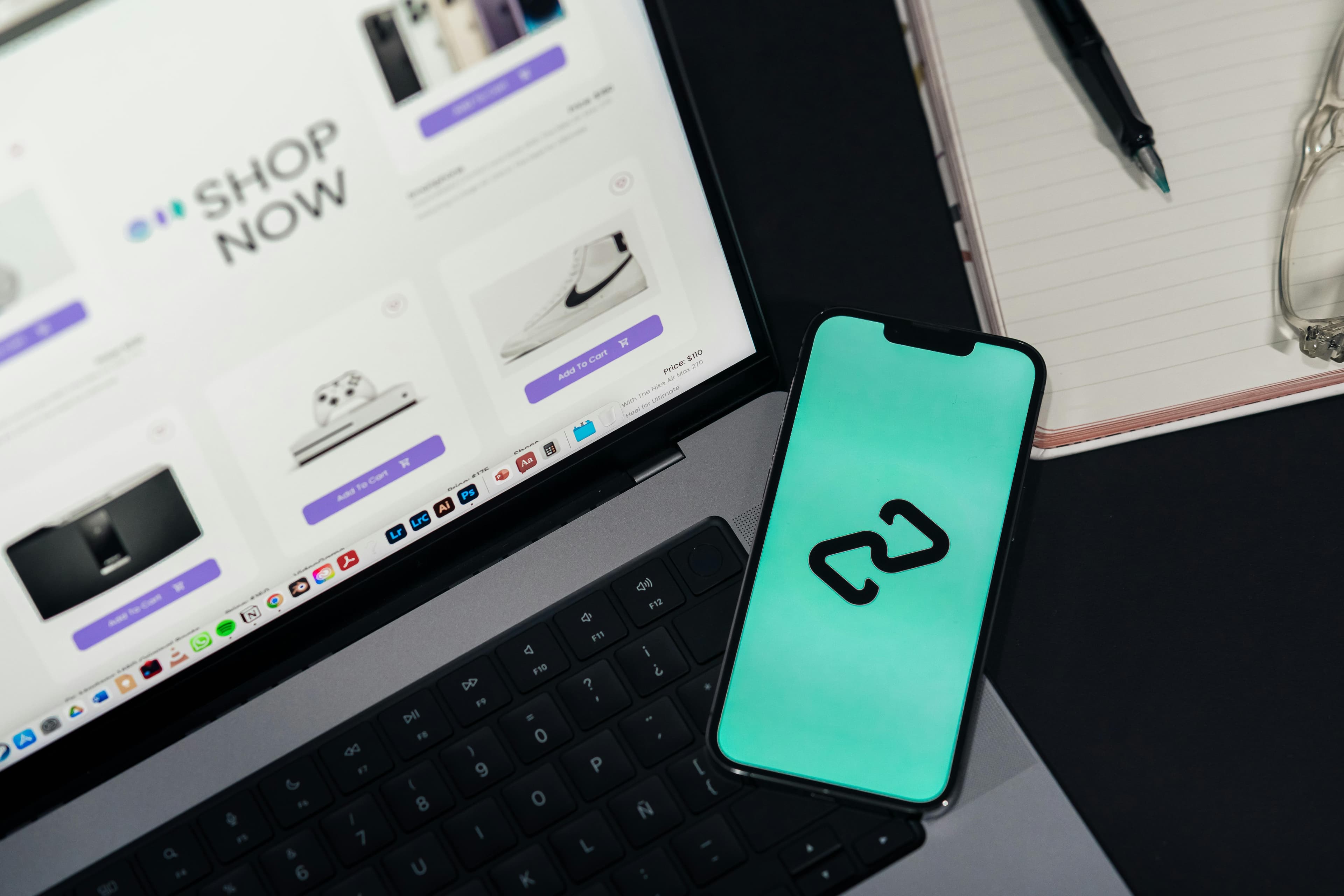A smartphone and laptop displaying online platforms
