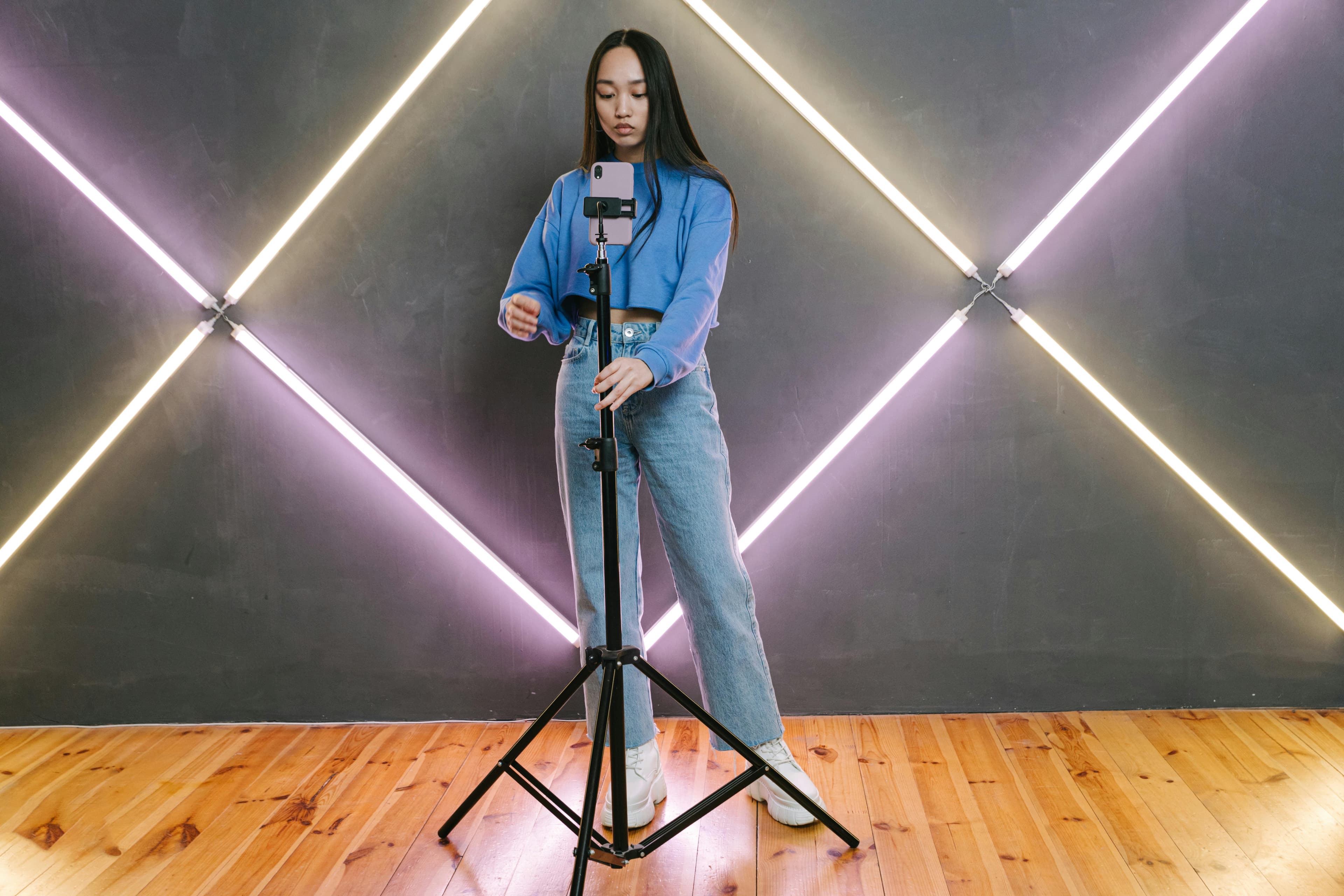 A creator preparing to film vertical video with a smartphone on a tripod